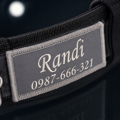 Close-up of personalized embroidered name patch on wide tactical dog collar showing custom dog name and phone number — heavy duty padded dog collar